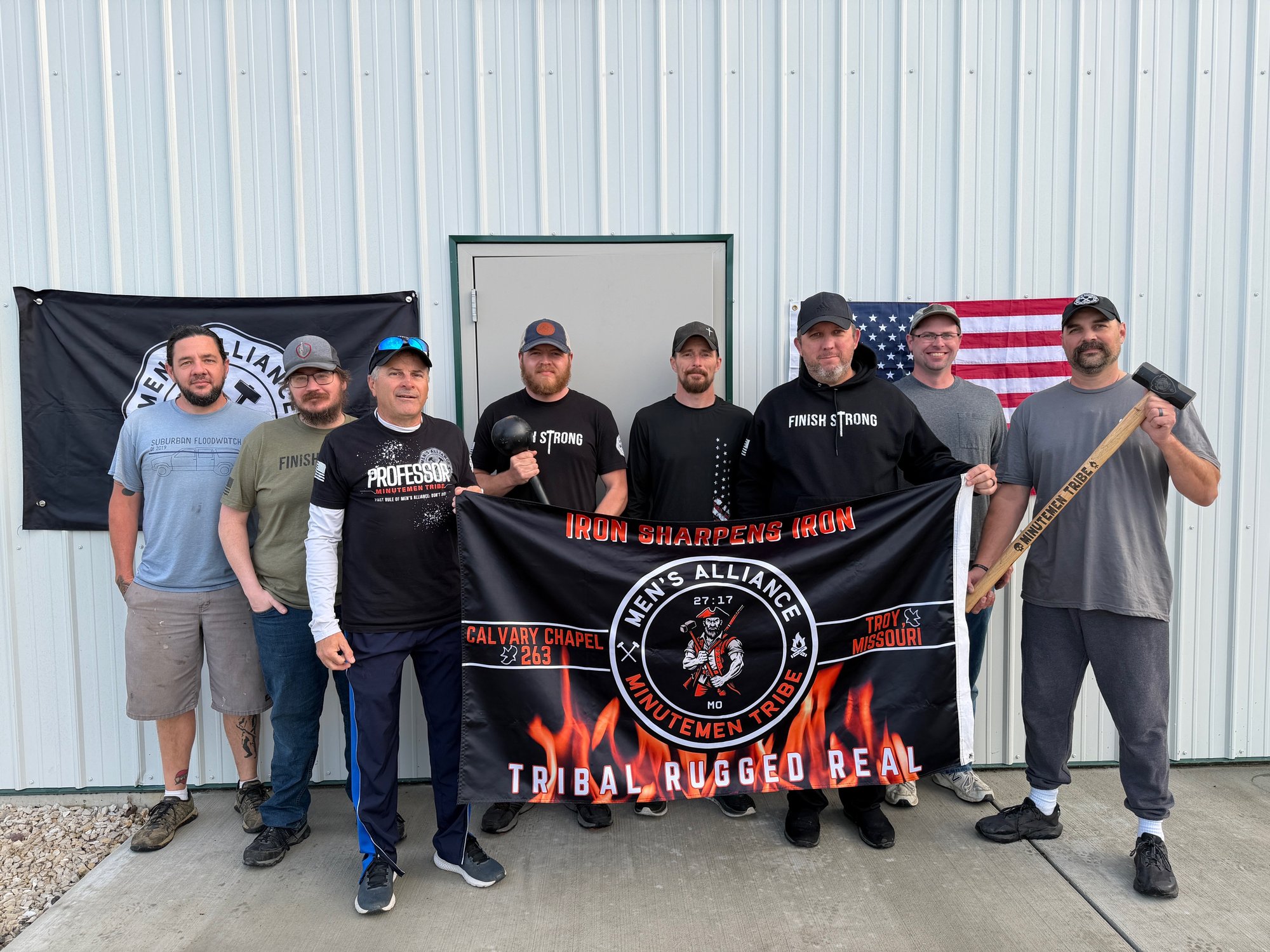 The Chiefs of Minutemen Tribe standing in front of the Men's Alliance flag at Calvary Chapel Troy